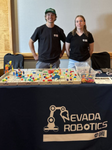 Two members of the Nevada Robotics standing at their booth.