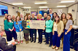People standing around a check from NVEnergy